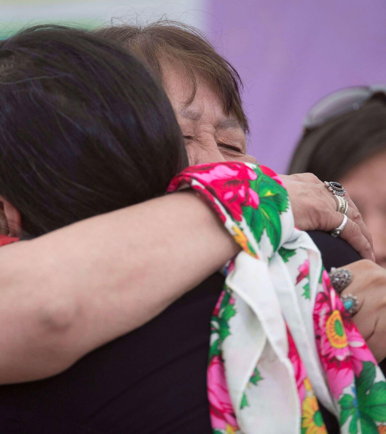 Two women hugging.