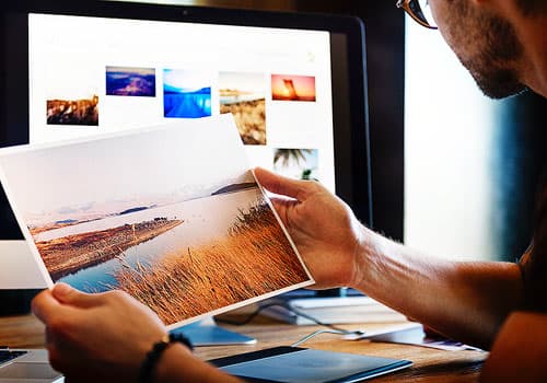 Man holding a scenic picture.