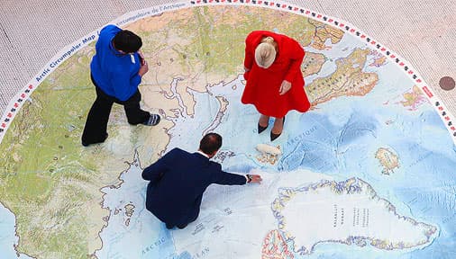 people walking over a map showing the regions of the world