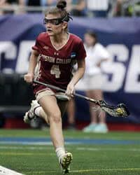 Female lacrosse player running.