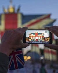 Picture of someone holding a cell phone taking a picture of the union jack flag