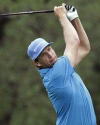 Golfer swinging.
