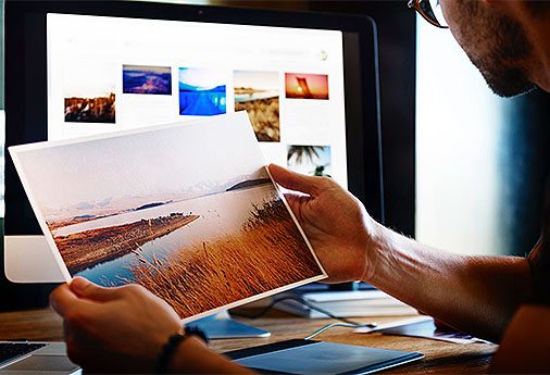 Man holding a scenic picture.