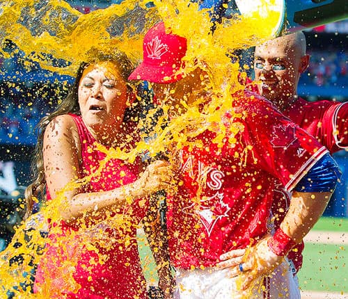 Toronto Blue Jays Steve Pearce and Sportsnet's Hazel Mae get a gatorade shower from Blue Jay teammates.