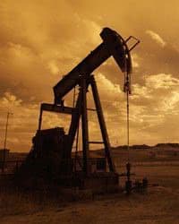 Silhouette of an oil rig in the desert.