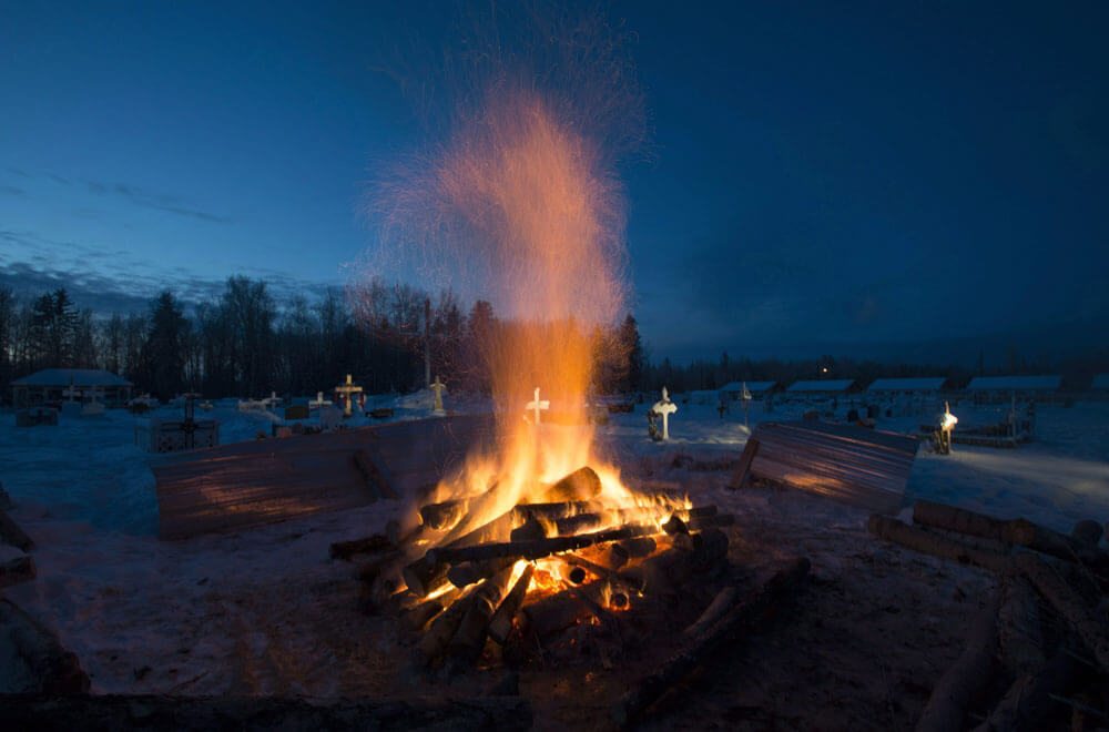 A fire burns to melt the ground so a grave can be dug at the cemetery in La Loche, Sask.