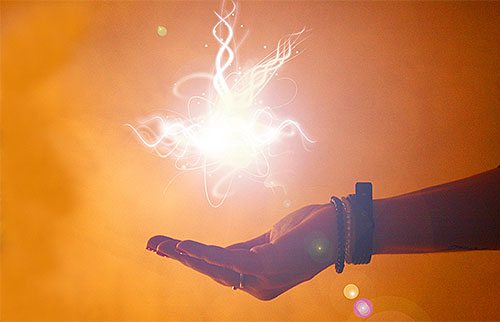 A hand holding a flash of light.