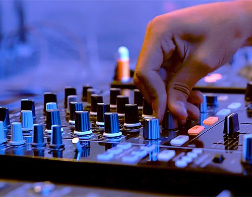 Man working on a sound board.