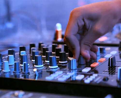 A man operating a mixing sound board.