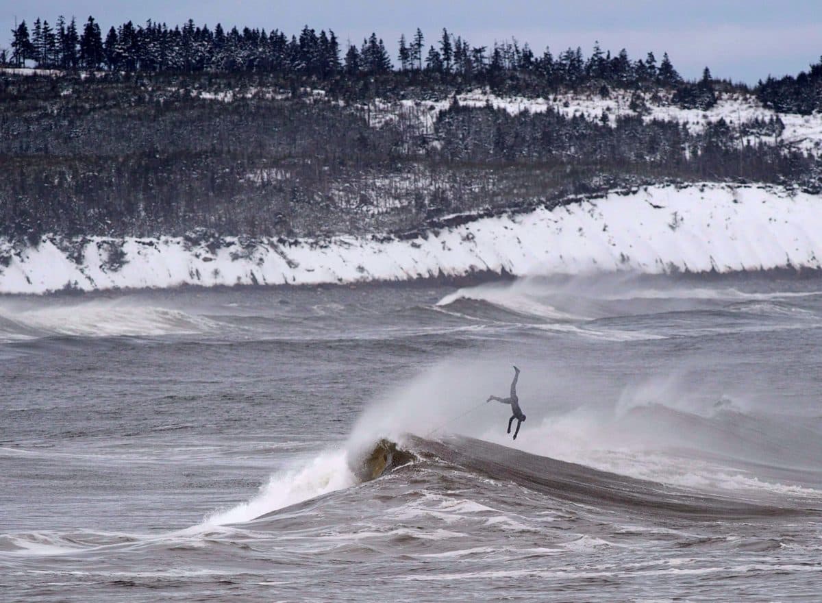 A surfer comes off a wave in Cow Bay, Nova Scotia.