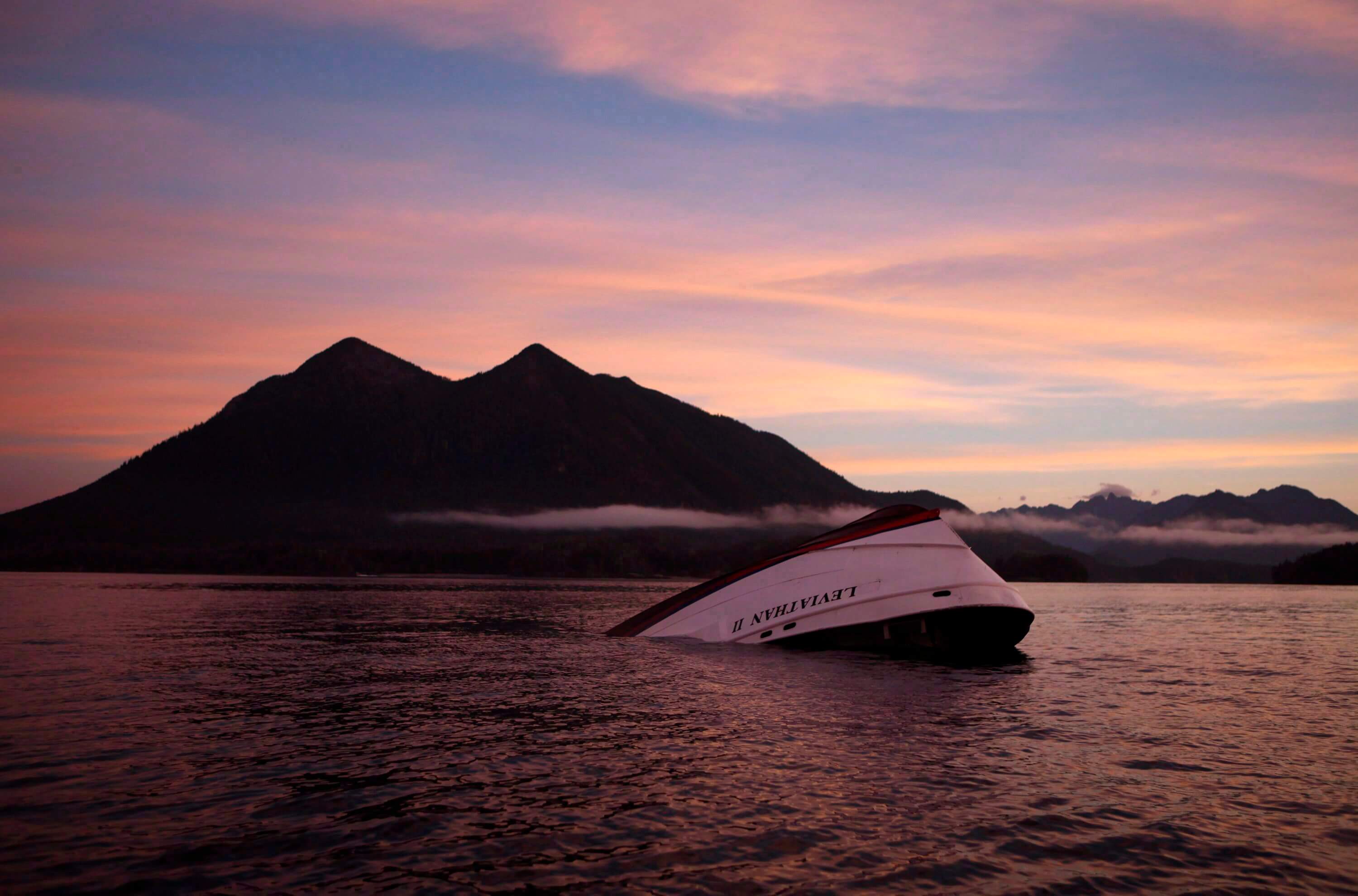 A whale boat in the process of sinking.