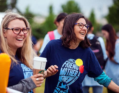 Picture of two women laughing at a fundraiser.