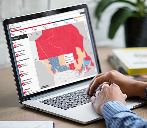 Map of Canada and the United States displayed on a computer monitor with sections in different colors.