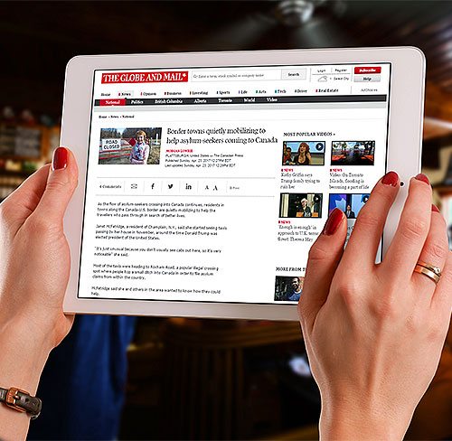 Globe and Mail website displayed on tablet.