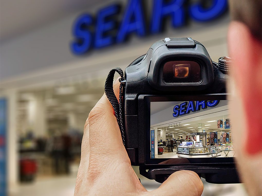A photographer captures a department storefront