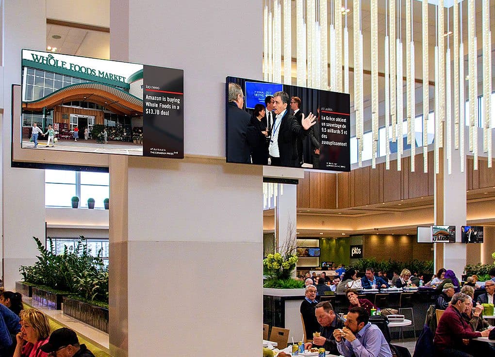 Neo Traffic screens displaying The Canadian Press news on digital screens in a mall foodcourt