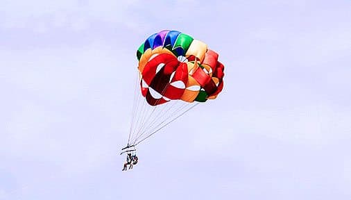 A couple descending with a parachute