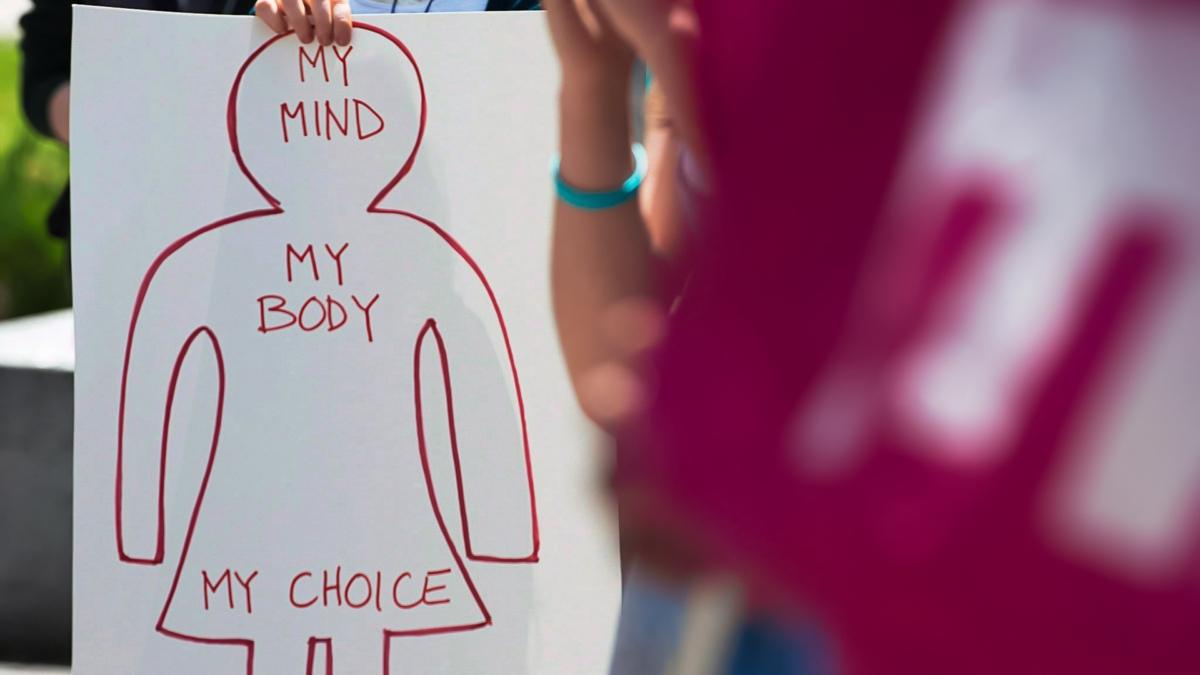 a protest sign marking poor access to abortion services in Nova Scotia