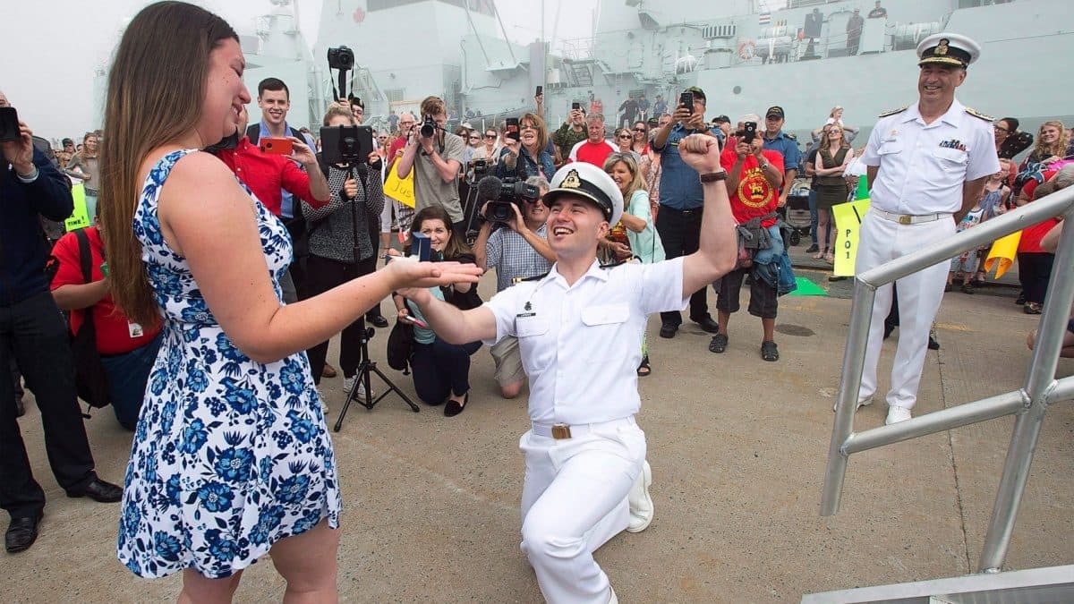 a sailor reacting after his girlfriend accepted his marriage proposal