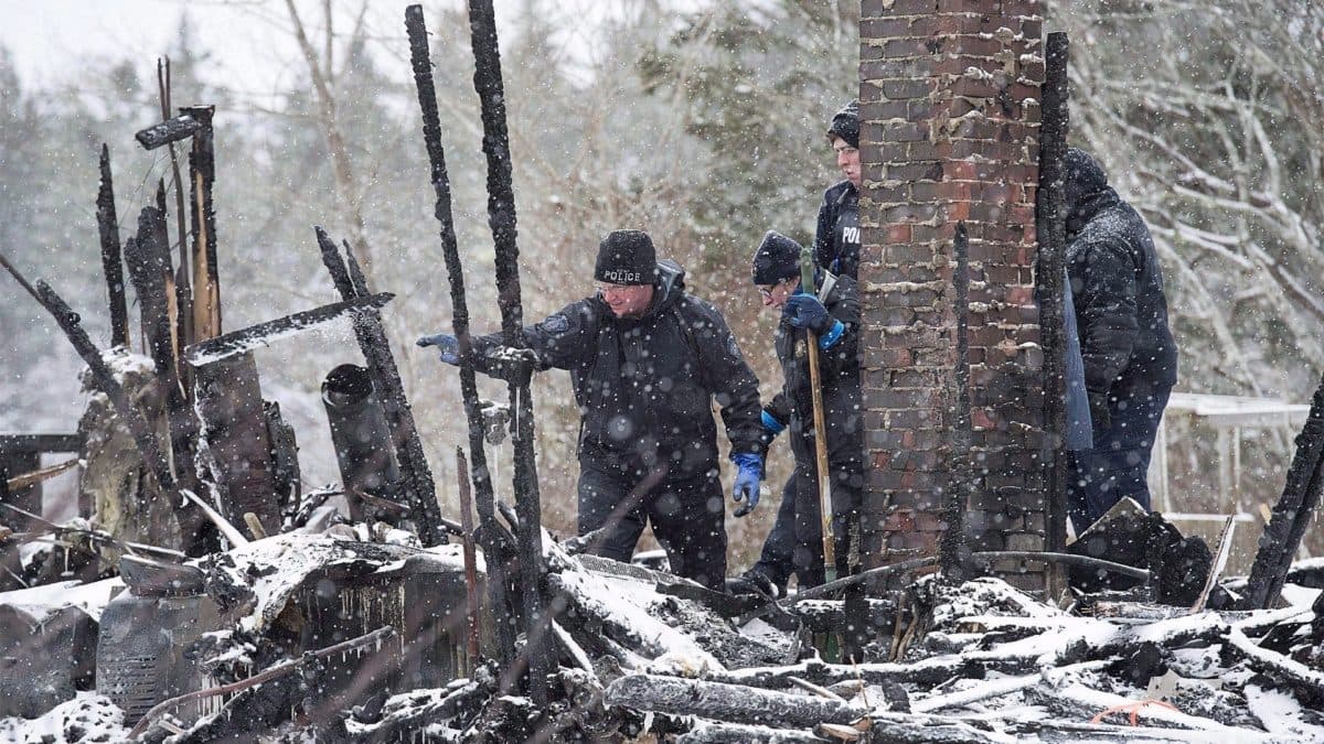 police explore a house fire that left four people dead