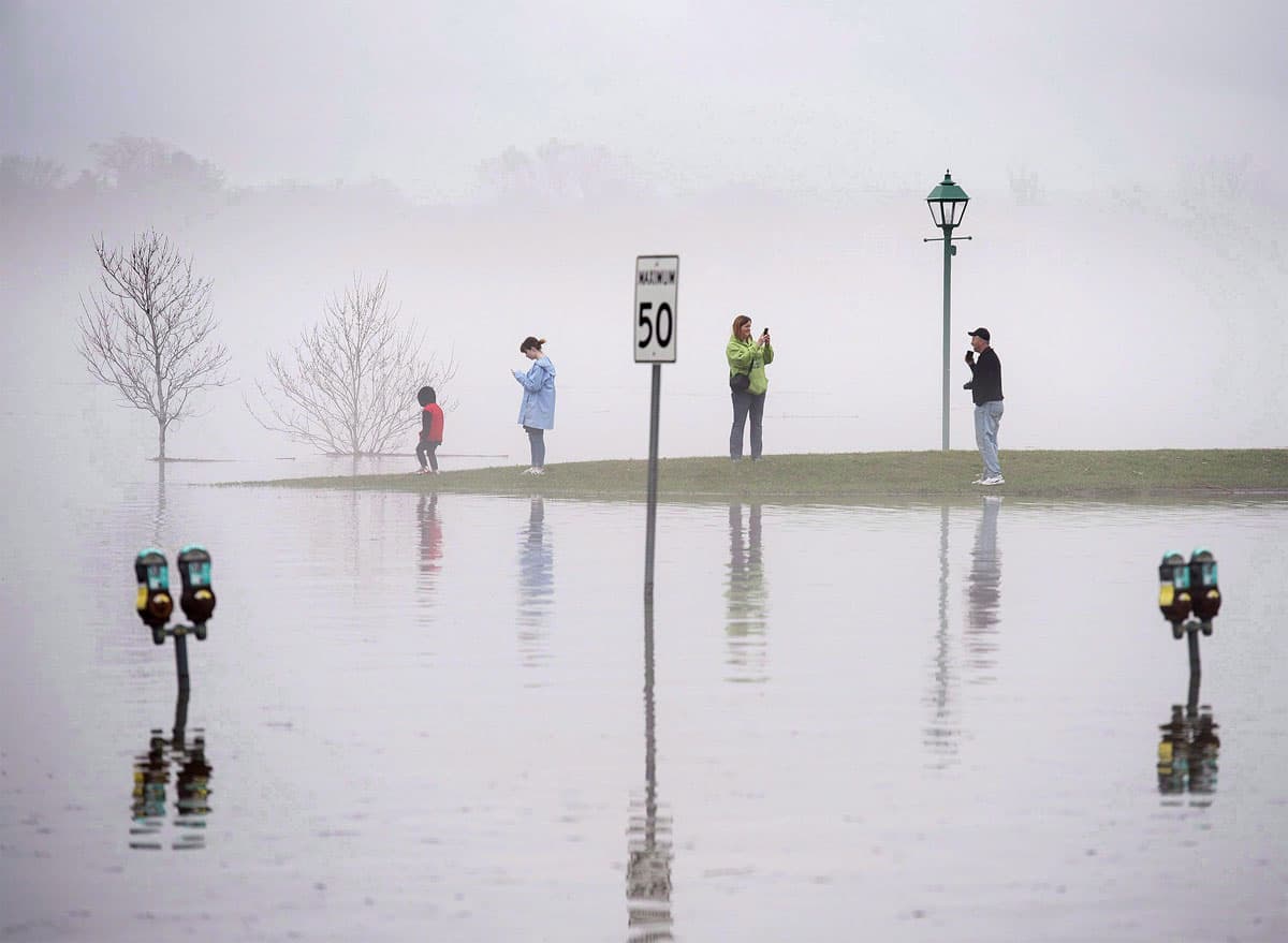 Fog shrouds the waterfront as the St. John River water levels rise.