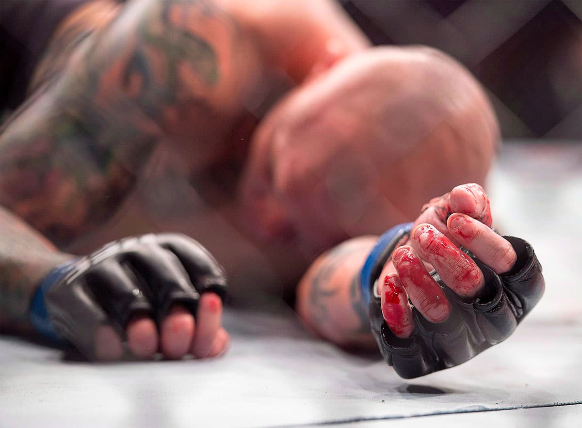 Anthony Smith lays on the canvas after defeating Volkan Oezdemir.