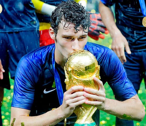 France's Benjamin Pavard kisses the cup during the trophy ceremony after the final match between France and Croatia