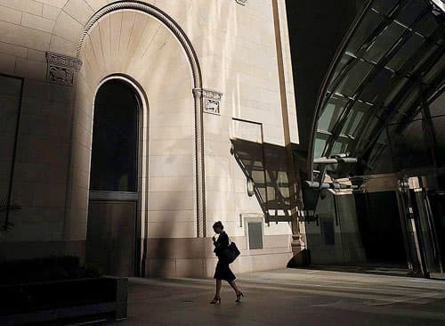 A woman walks through Toronto's financial district.