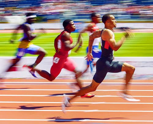 Andre De Grasse, right, of Canada sprints during the men's 200m heats