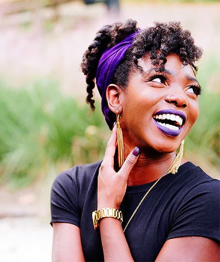 woman touching neck while laughing