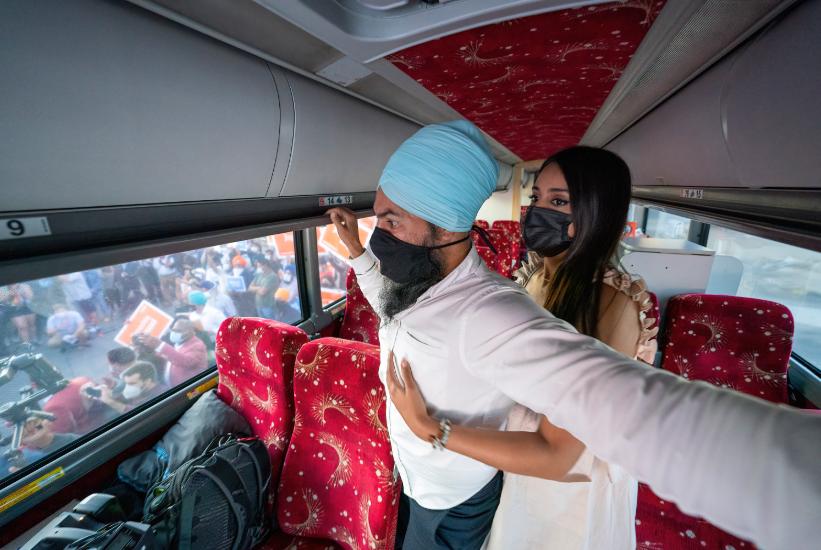 Jagmeet Singh and his wife hug on the bus during his election campaign