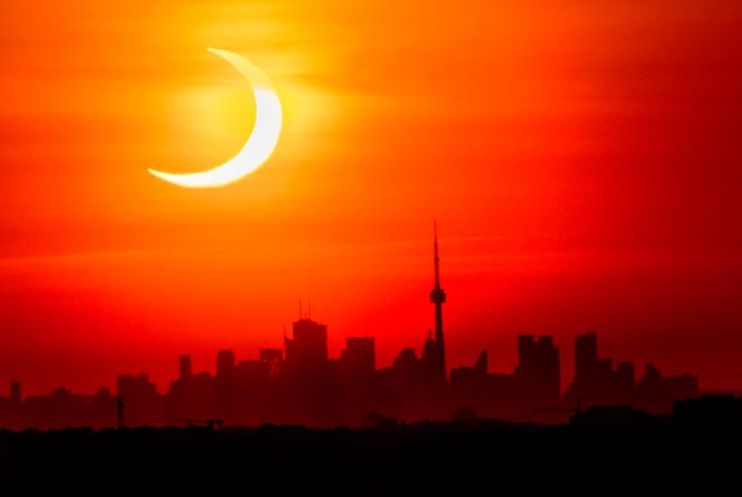 Solar exclipe is pictured with the Toronto skyline in the background