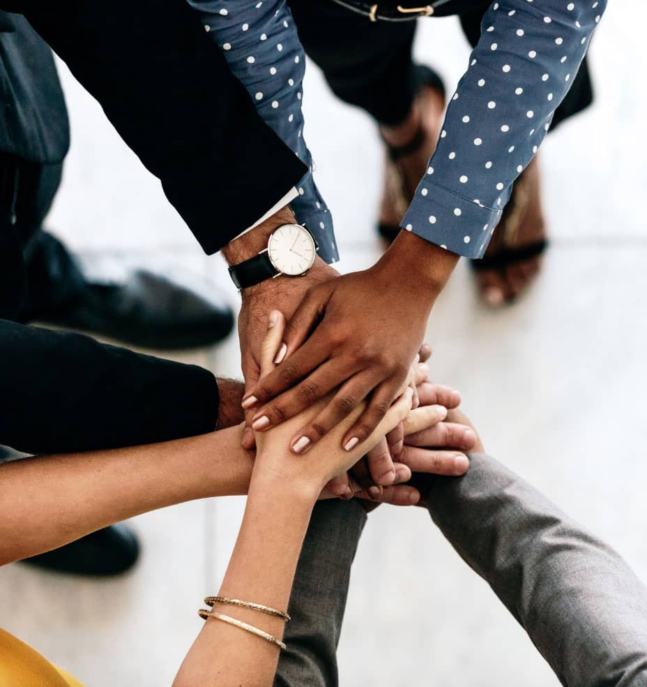 A team with their hands in a circle