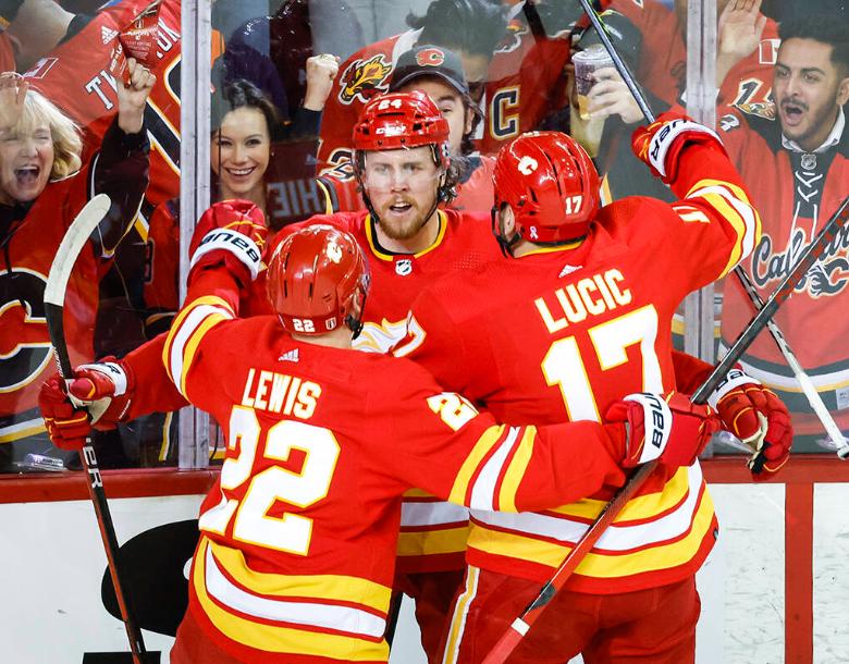 Calgary Flames forward Brett Ritchie, centre, celebrates his goal with teammates centre Trevor Lewis (22) and left wing Milan Lucic (17) during first period NHL second round playoff hockey action against the Calgary Flames in Calgary, Wednesday, May 18, 2022.THE CANADIAN PRESS/Jeff McIntosh