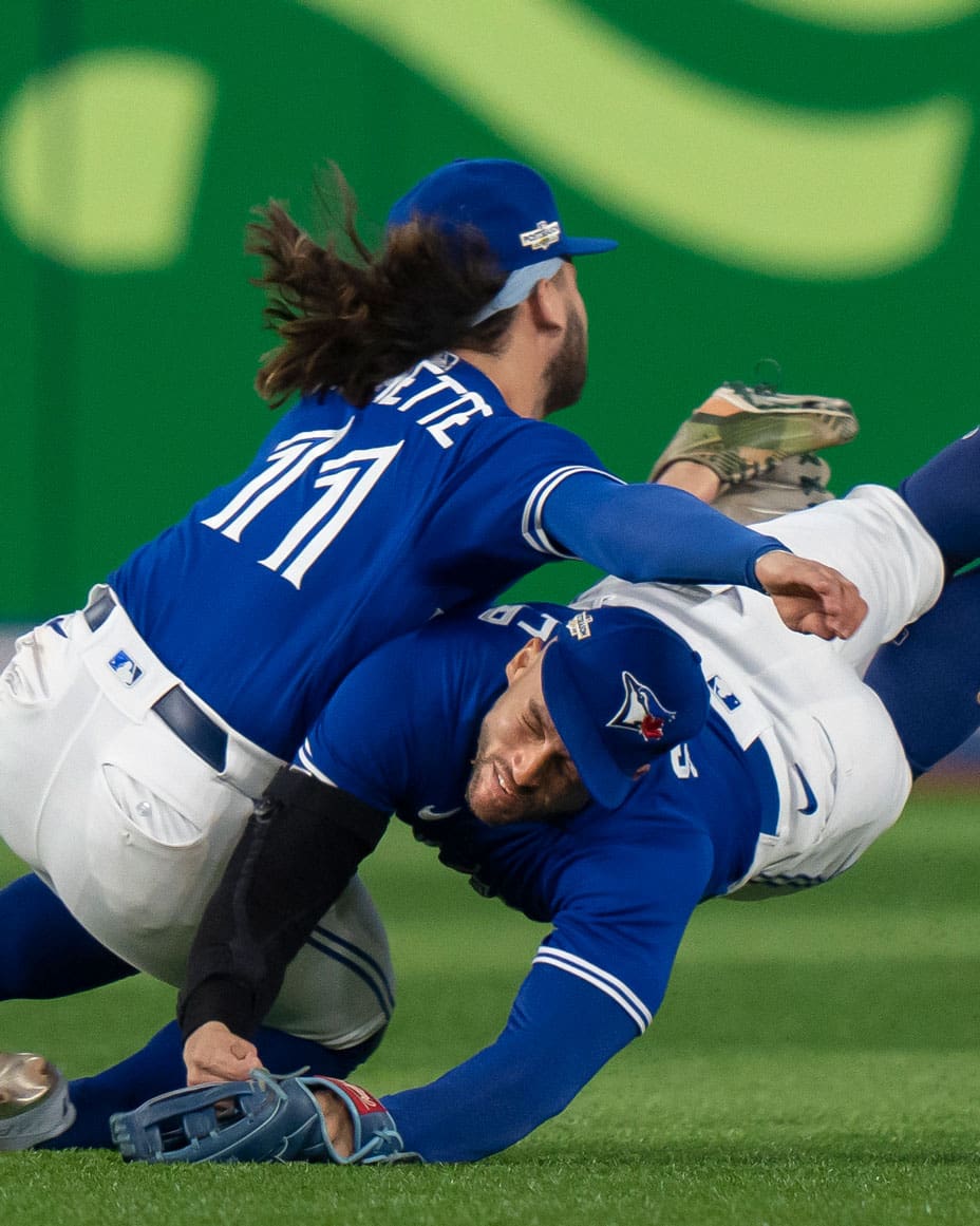 Toronto Blue Jays shortstop Bo Bichette (11) and Toronto Blue Jays centre fielder George Springer (4) collide while to trying to catch a short fly ball.