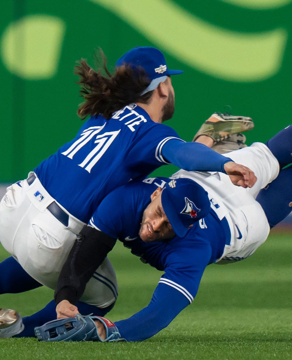 Toronto Blue Jays shortstop Bo Bichette (11) and Toronto Blue Jays centre fielder George Springer (4) collide while to trying to catch a short fly ball.